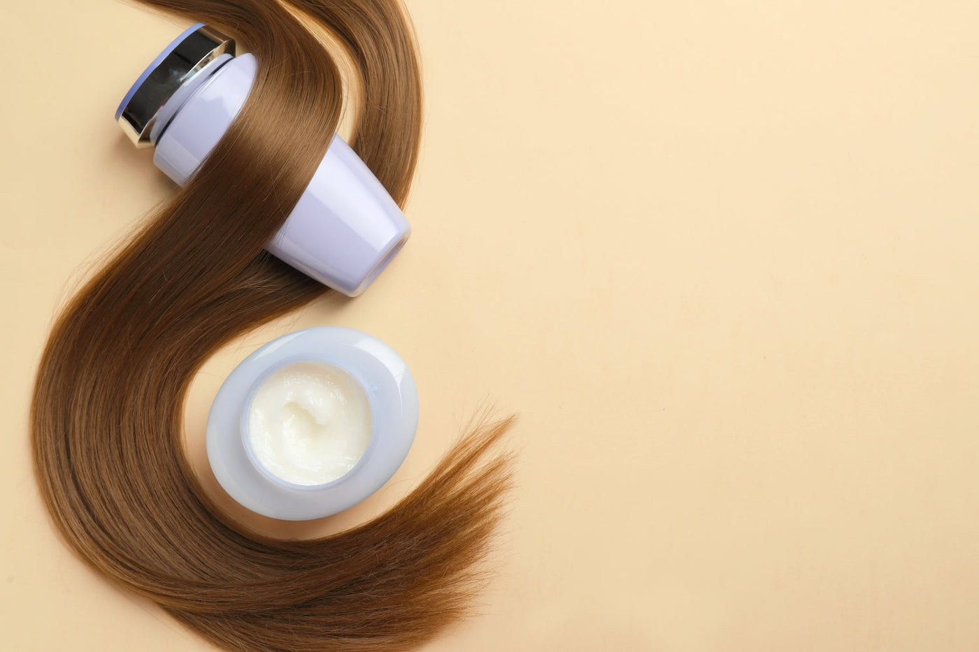 Smooth, clean and healthy hair extensions wrapped around shampoo bottles