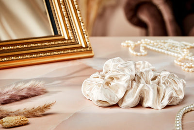 Phoenix Crown Satin Scrunchie Trio product featuring 2 of the 3 scrunchies on a glamorous backdrop scene