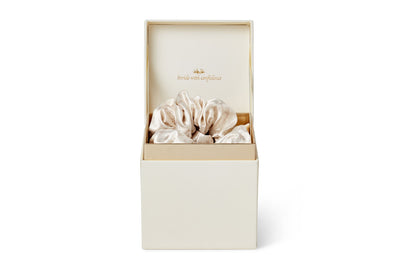 A front view of Phoenix Crown Satin Scrunchie Trio displayed in their luxurious box with tagline